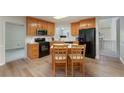 A well-lit kitchen with wooden cabinets, black appliances and island with chairs at 332 Red Fox Dr, Canton, GA 30114