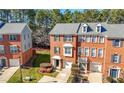 Brick townhome with an attached garage and well-maintained landscaping at 5589 Trace Views Dr, Norcross, GA 30071