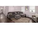 Cozy living room featuring a large sectional sofa, ottoman, and a patterned rug at 6547 Demere Dr, Morrow, GA 30260