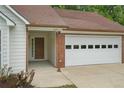 Close up of the home's entrance and garage with brick accents and fresh landscaping at 1095 Athena Ct, Acworth, GA 30101
