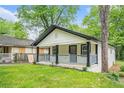 Quaint home featuring a covered front porch, providing shade and character to the property at 1477 Olive Sw St, Atlanta, GA 30310
