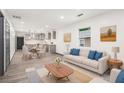 Bright, open-concept living room with modern decor and hardwood flooring at 1477 Olive Sw St, Atlanta, GA 30310