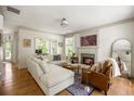Inviting living room features a cozy fireplace, hardwood floors, and neutral decor with lots of natural light at 6000 Hampton Bluff Way, Roswell, GA 30075