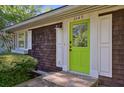 Close-up of a home's bright green front door, cedar shake siding and white trim at 2049 Oakview Se Rd, Atlanta, GA 30317