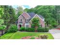 Charming two-story brick home boasts lush landscaping and inviting curb appeal at 2973 Misty Rock Cv, Dacula, GA 30019