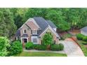 Beautiful two-story brick home featuring a well-manicured lawn and long driveway at 2973 Misty Rock Cv, Dacula, GA 30019
