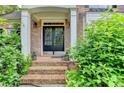 Inviting front entrance with brick steps and decorative foliage at 2973 Misty Rock Cv, Dacula, GA 30019