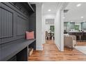 Inviting entryway with a gray mudroom area, hardwood floors, and view of kitchen and dining at 4327 Wellington Hills Ln, Snellville, GA 30039