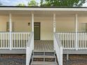 Inviting front porch featuring gray steps and railing, offering a charming welcome at 5438 Hiram Lithia Springs Rd, Powder Springs, GA 30127