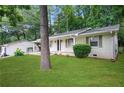 Side view of a charming single-story home with a lush lawn and a convenient covered carport at 2732 Elkhorn Dr, Decatur, GA 30034