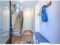 Inviting entryway with hardwood floors, a staircase, and a coat rack at 834 S Columbia Dr, Decatur, GA 30030