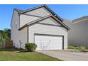 Two story home with attached two car garage and well manicured lawn at 111 Centennial Ridge Dr, Acworth, GA 30102