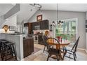 This eat-in kitchen includes stainless appliances, dark cabinetry, a tile backsplash, and barstool seating at 141 Springbrooke Trl, Dallas, GA 30157