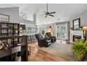 An open-concept living room features a fireplace, French doors, high ceilings, and a view into the kitchen at 141 Springbrooke Trl, Dallas, GA 30157