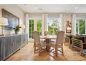 Charming dining room with hardwood floors, complemented by stylish furnishings and natural light from the large windows at 1430 Dresden Ne Dr # 230, Brookhaven, GA 30319
