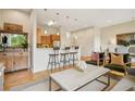 Cozy living room showcasing hardwood floors, seating area, and barstool seating at the kitchen counter at 1430 Dresden Ne Dr # 230, Brookhaven, GA 30319