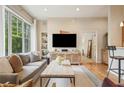 Inviting living room with hardwood floors, a large window, and a media center with a flat screen TV at 1430 Dresden Ne Dr # 230, Brookhaven, GA 30319