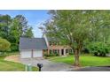 Charming two-story brick home with a well-manicured lawn and a two-car garage at 2801 Holly Oaks Dr, Marietta, GA 30062