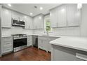 Modern kitchen featuring stainless steel appliances, white countertops, and gray shaker cabinets at 2801 Holly Oaks Dr, Marietta, GA 30062