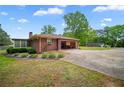 View of the home featuring an attached garage and a spacious driveway at 110 Otelia Ln, Covington, GA 30014