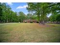 A charming brick home featuring a spacious front lawn and mature shade trees at 110 Otelia Ln, Covington, GA 30014