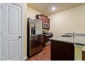Kitchen featuring granite countertops, stainless steel appliances, and dark wood cabinets at 507 Highwood Ln, Atlanta, GA 30344