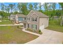 Charming two-story home with a brick facade, attached garage, manicured lawn and extended driveway at 571 Hancock Se Dr, Atlanta, GA 30354