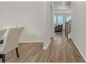 Bright hallway with hardwood floors leading to a living room with abundant natural light from multiple windows at 571 Hancock Se Dr, Atlanta, GA 30354