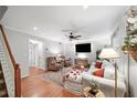 Spacious living room featuring hardwood floors, a cozy seating area, and a modern entertainment center at 6900 Roswell Rd # J2, Atlanta, GA 30328