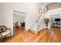 Spacious foyer with hardwood floors, staircase, and views into the office and living room at 2321 Edgemere Lake Cir, Marietta, GA 30062