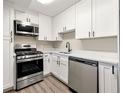 Well-lit kitchen featuring modern stainless steel appliances, white cabinets, and light countertops at 2965 Pharr Court South Nw # 718, Atlanta, GA 30305
