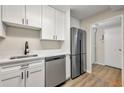 Updated kitchen with stainless steel appliances, sleek white cabinets, and modern countertops at 2965 Pharr Court South Nw # 718, Atlanta, GA 30305