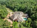 Expansive estate featuring a beautiful home, a pool, and surrounded by lush greenery at 320 Riverbend Dr, Mcdonough, GA 30252