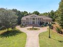 Aerial view of a large brick home with a circular driveway at 320 Riverbend Dr, Mcdonough, GA 30252