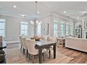 Elegant dining area featuring a large table, comfortable chairs, and ample natural light, perfect for Gathering gatherings at 7220 Winderlea Ln, Cumming, GA 30040