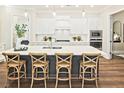 Bright kitchen with a large island, stylish bar stools, and modern white cabinetry, ideal for entertaining at 7220 Winderlea Ln, Cumming, GA 30040