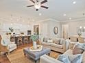 Open-concept living area with stylish furniture, seamlessly connected to the kitchen and dining space at 7220 Winderlea Ln, Cumming, GA 30040