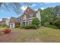 Beautiful brick home featuring a two-car garage and lush landscaping on a well-maintained lawn at 5155 Amberden Hall Dr, Suwanee, GA 30024