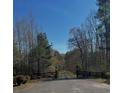 Long driveway leading to a home, framed by a wooden fence at 7180 Westray Rd, Cumming, GA 30028