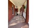 Covered brick porch featuring ceiling fans, hanging ferns, and a view of the surrounding landscape at 7180 Westray Rd, Cumming, GA 30028