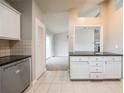 Kitchen area with white cabinets, stainless steel appliances, and tiled backsplash at 2132 Sara Ashley Way, Lithonia, GA 30058