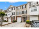 Well-maintained townhouse exterior featuring brick accents and convenient attached garages at 2513 Ivey Crest Cir, Tucker, GA 30084