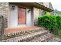 Inviting entrance featuring a brick-paved landing and brick steps, providing a warm welcome at 620 Shannon Green Sw Cir, Mableton, GA 30126