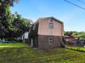 View of the home's back exterior with brick on the bottom half and siding on the top half at 10 Hawk Nw Rd, Cartersville, GA 30121