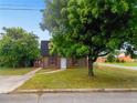 Charming home with a brick facade and a large tree in the front yard at 10 Hawk Nw Rd, Cartersville, GA 30121