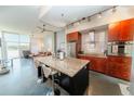 Open kitchen featuring granite countertops, stainless steel appliances, and an island with bar seating at 130 Arizona Ne Ave # 309, Atlanta, GA 30307