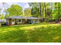 View of the expansive yard highlighting the lush greenery and wooded backdrop at 2558 Landeau Cir, Tucker, GA 30084