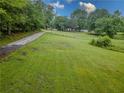 Beautiful property featuring a well-maintained lawn, mature trees, and a peaceful, natural setting at 3241 Briscoe Rd, Loganville, GA 30052