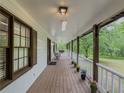 Cozy front porch with seating, potted plants, and a serene view of the surrounding landscape at 3241 Briscoe Rd, Loganville, GA 30052