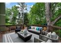 Relaxing outdoor deck featuring stylish seating, modern decor, and a serene wooded view at 790 Thornberry Dr, Alpharetta, GA 30022